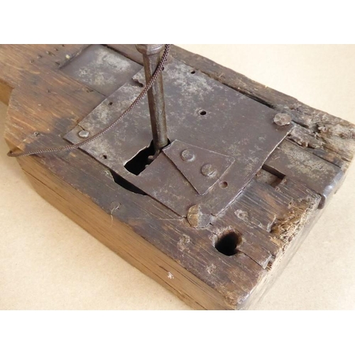 461 - An 18th century large lock mechanism and key with working action, with original fittings (38cm long ... 