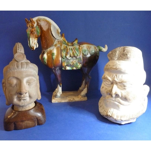 469 - A Tang pottery head of a Lokapala, an Asian terracotta head on a hardwood stand and a Chinese potter... 