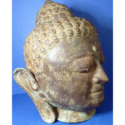 485 - An antique bronze Buddha head (33cm high)