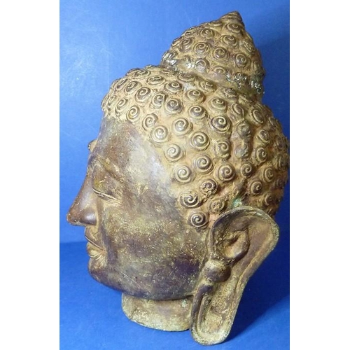 485 - An antique bronze Buddha head (33cm high)