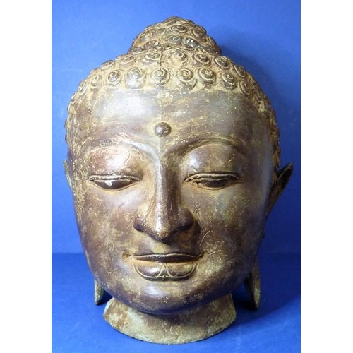 485 - An antique bronze Buddha head (33cm high)