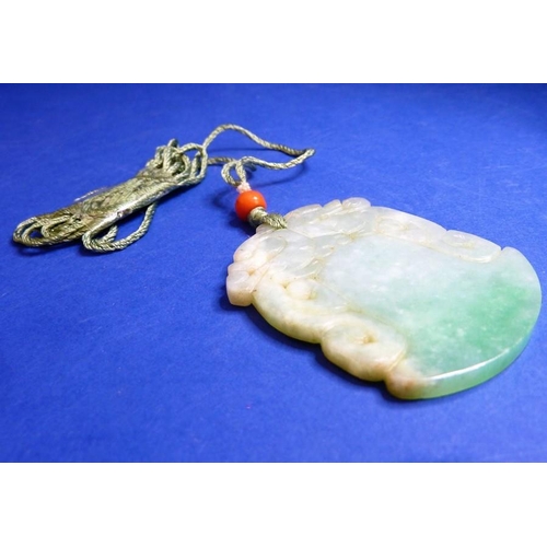 489 - A jadeite axe-form double dragon pendant on silk cord with a red-coral bead bound with seed pearls (... 