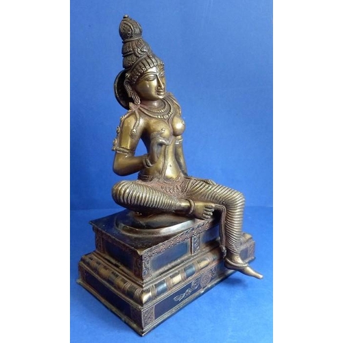 491 - A Tamil Nadu Southern India cast-bronze Parvathi figure in Bogashakti form, seated on a stepped lacq... 