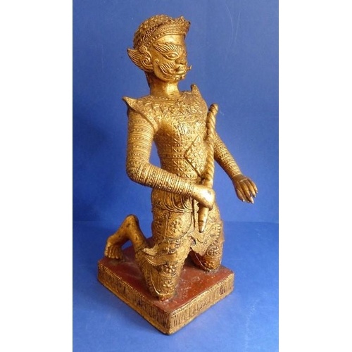 492 - A Rattanakosin period (1782 – 1932) gilt masked kneeling figure, the base decorated with red lacquer... 