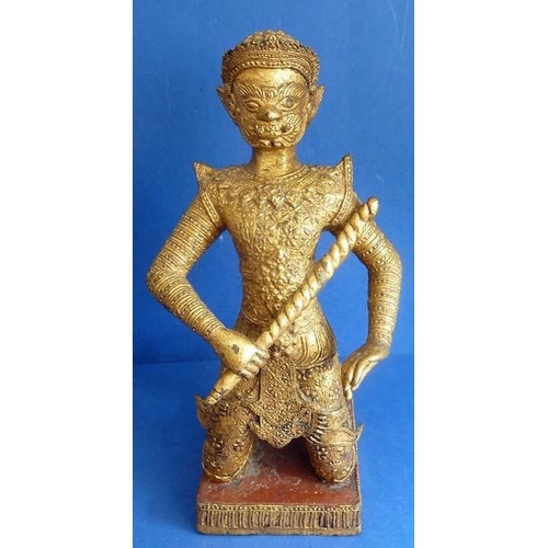 492 - A Rattanakosin period (1782 – 1932) gilt masked kneeling figure, the base decorated with red lacquer... 