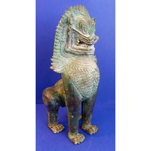 495 - An antique Cambodian South-East Asian bronze Singha guardian temple lion (41cm high)