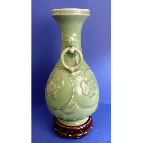 499 - A Chinese celadon vase on hardwood stand