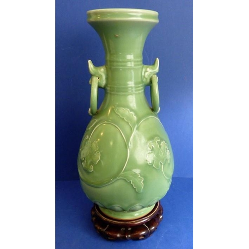 499 - A Chinese celadon vase on hardwood stand