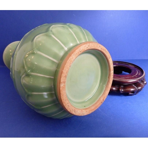 499 - A Chinese celadon vase on hardwood stand