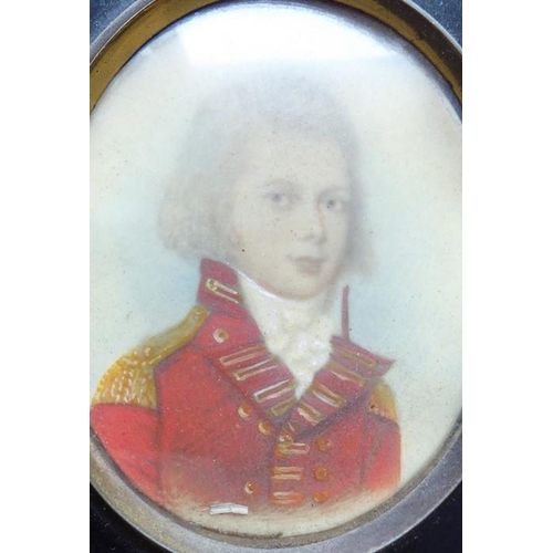 511 - A late 18th/early 19th century shoulder-length portrait miniature study of a young boy in red milita... 