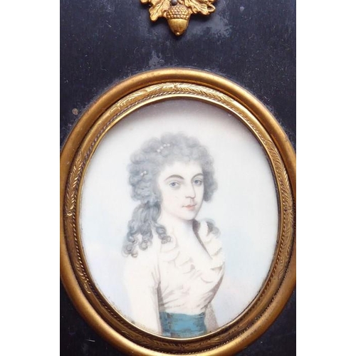 512 - A 19th century oval half-length portrait miniature study of a young lady with long curly dark hair a... 