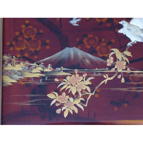 514 - A fine early 20th century framed Japanese red-lacquer and gilt panel depicting Mount Fuji with prunu... 