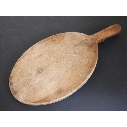 541 - A Robert 'Mouseman' Thompson of Kilburn oval oak cheeseboard, the handle with signature mouse (37.5c... 