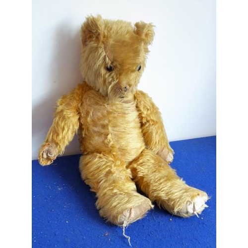 551 - A mid-20th century plush mohair teddy bear; growling mechanism not working and in play-worn conditio... 