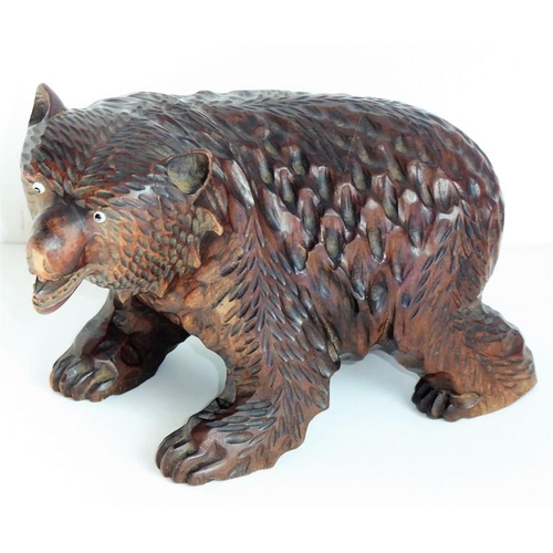 557 - A good and heavy late 19th century carved Black Forest bear; standing four square, with open mouth a... 