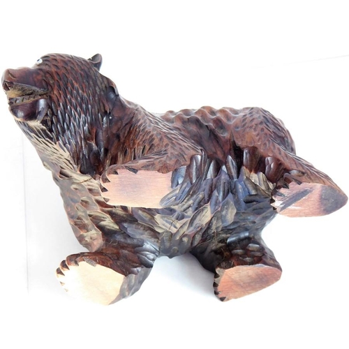 557 - A good and heavy late 19th century carved Black Forest bear; standing four square, with open mouth a... 