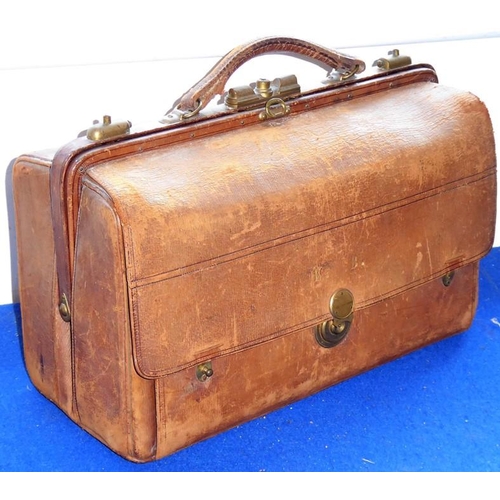 558 - An early 20th brown-leather vanity case; two compartments, one compartment opening to reveal various... 