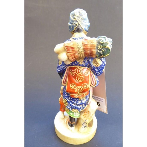 56 - A late 19th/early 20th century Japanese porcelain figure; the blue-robed female with head covering a... 