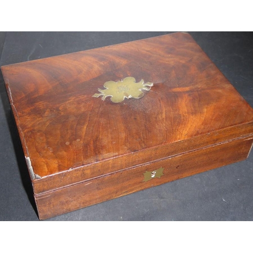 563 - A 19th century flame mahogany-veneered velvet lined box; the ornate inset brass cartouche engraved w... 