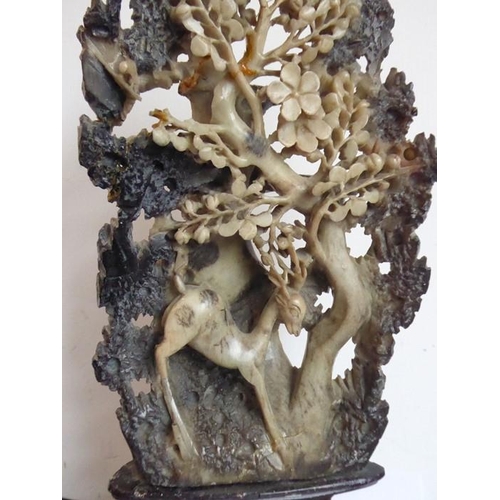 580 - An early 20th century carved Chinese soapstone model of a leaping deer (Lu) underneath a tree with p... 