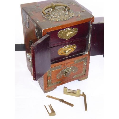 581 - A late 19th century Chinese brass bound hardwood table cabinet, the swing handle as a Shou character... 