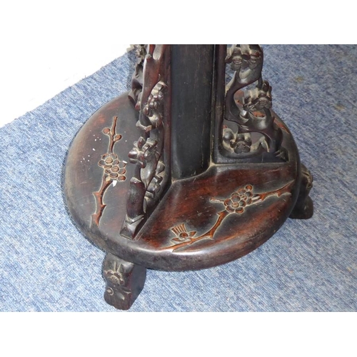 582 - An early 20th century Chinese hardwood lamp standard carved in high relief with prunus blossom etc. ... 