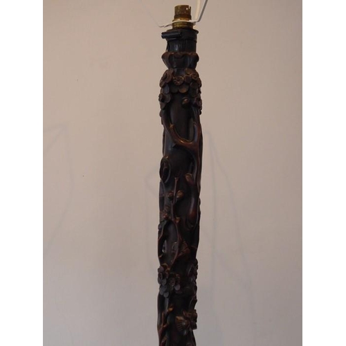 582 - An early 20th century Chinese hardwood lamp standard carved in high relief with prunus blossom etc. ... 