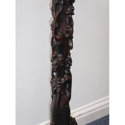 582 - An early 20th century Chinese hardwood lamp standard carved in high relief with prunus blossom etc. ... 