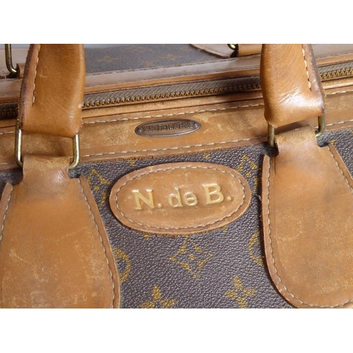 583 - A genuine hand-stitched tan-leather trimmed Louis Vuitton carry bag (Paris, France); applied hand-st... 