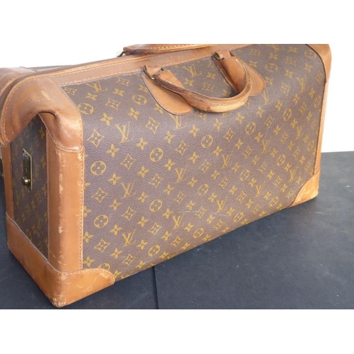 583 - A genuine hand-stitched tan-leather trimmed Louis Vuitton carry bag (Paris, France); applied hand-st... 