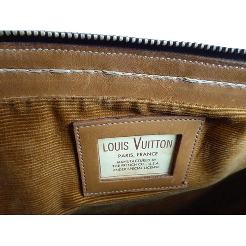 583 - A genuine hand-stitched tan-leather trimmed Louis Vuitton carry bag (Paris, France); applied hand-st... 