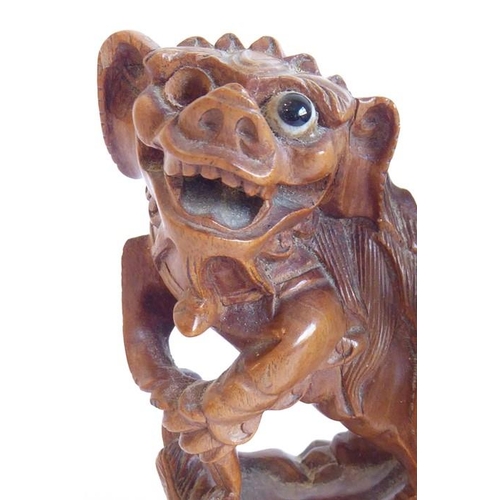 590 - A finely carved 19th century Chinese model of a qilin-style creature with bifid tail; the front legs... 