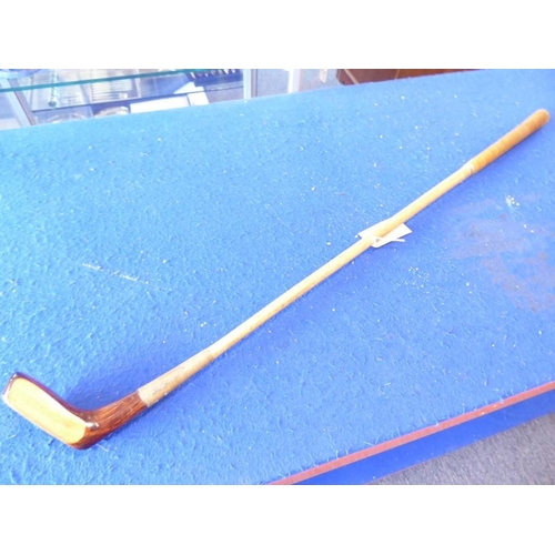 594 - A hickory-shafted golf putter; brown-suede handle and handmade in St Andrews, Scotland, 'The Laird',... 