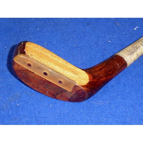 594 - A hickory-shafted golf putter; brown-suede handle and handmade in St Andrews, Scotland, 'The Laird',... 