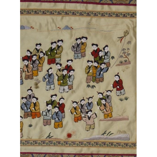 599 - A Chinese silk work finely embroidered with many figures, the central figures holding aloft and carn... 