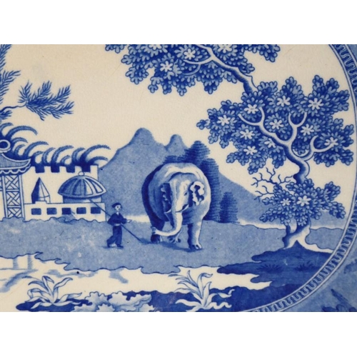 60 - An early 19th century blue-and-white platter unusually depicting an elephant and attendant before Or... 