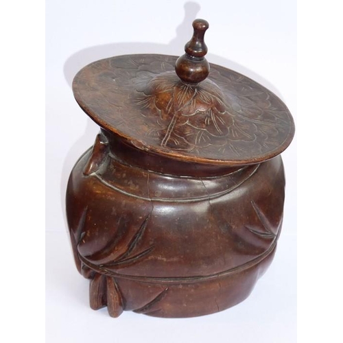 602 - A late 19th/early 20th century Chinese hardwood tobacco jar carved in the shape of a cloaked gentlem... 