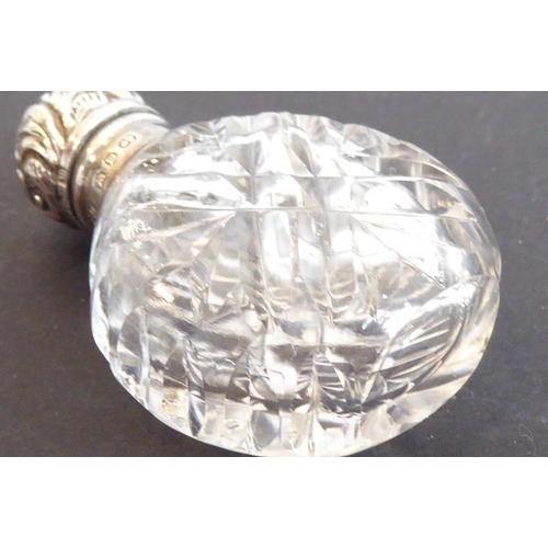 608 - A fine late 19th century cut glass and silver mounted scent bottle; the hinged cover decorated repou... 