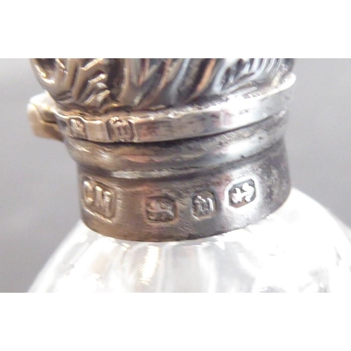 608 - A fine late 19th century cut glass and silver mounted scent bottle; the hinged cover decorated repou... 