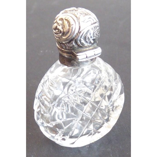 608 - A fine late 19th century cut glass and silver mounted scent bottle; the hinged cover decorated repou... 