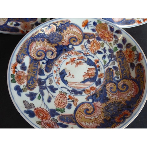 64 - Three Japanese porcelain dishes; each hand gilded and decorated in the Imari palette with iron oxide... 