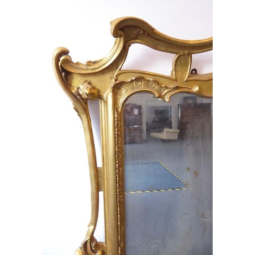 749 - A large 19th century gilt-framed wall-hanging looking glass in 18th century style; the pediment carv... 