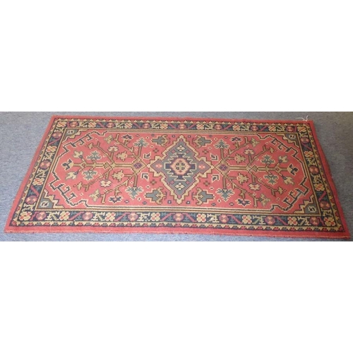 775 - A Turkish hand-knotted rug, predominately red ground (186cm x 95cm)