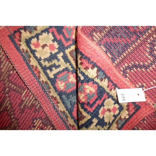 775 - A Turkish hand-knotted rug, predominately red ground (186cm x 95cm)