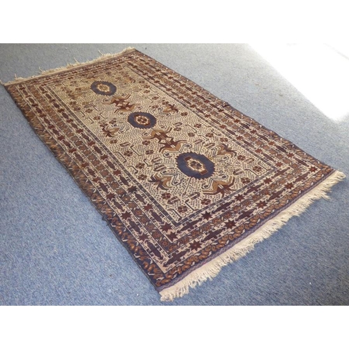 793 - An Afghan Baloch rug of predominately beige ground (203cm x 113cm)