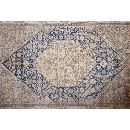 815 - A hand-knotted Tabriz rug (faded), probably late 19th century (196cm x 134cm)