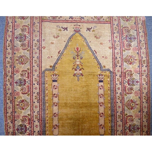 818 - A 19th century Turkish silk prayer rug having unusual yellow ground centre (184cm x 124cm)