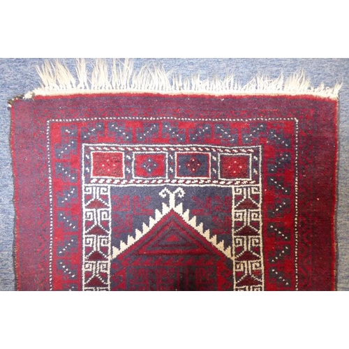 836 - A 20th century Baloch prayer rug, predominately red ground (142cm x 87cm)