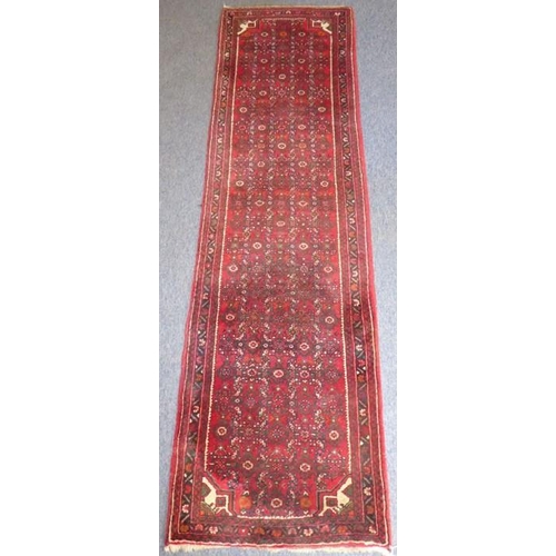 837 - A long north-west Persia Hamadan runner with red ground (297cm x 84cm)