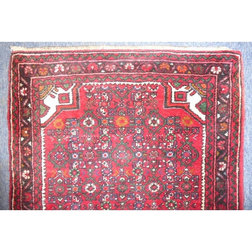 837 - A long north-west Persia Hamadan runner with red ground (297cm x 84cm)